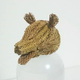 Illustration for article titled Godzilla Made from Pine Tree Branches Is a Lovely Fire Hazard